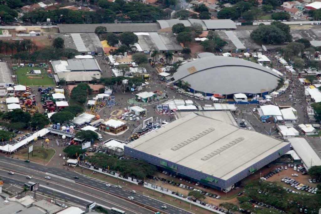 Aerial view of the Parque de Exposições in Maringá, featuring the Pavilhão Azul and a large domed arena during an event